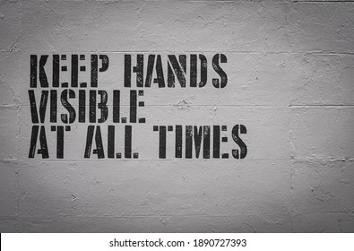 A Keep Hands Visible At All Times Sign On The Wall Of A Visitors Area Of A Prison Or Jail