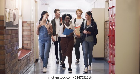 Keep Learning, Keep Moving Forward. Shot Of A Group Of Teenagers Walking Down The Hall At High School.