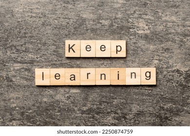 keep learning word written on wood block. keep learning text on table, concept.