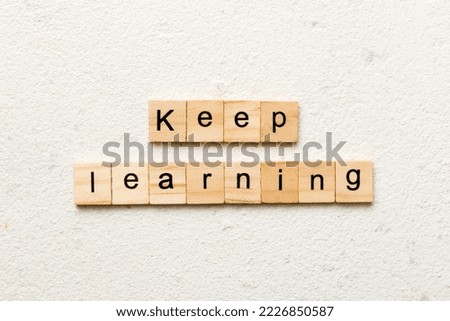 keep learning word written on wood block. keep learning text on table, concept.