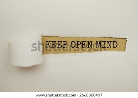 Keep Open Mind message written on craft paper with torn paper background