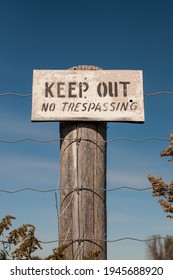 Keep Out No Trespassing Sign On An Old Fence Post