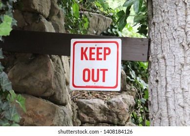 Keep Out Sign On Wooden Post