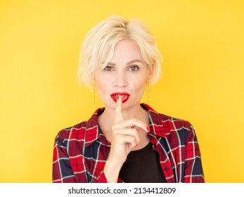 Keep Secret. Silent Woman. Face Expression. Amazed Beautiful Middle-aged Lady Holding Shush Finger On Mouth Isolated Yellow.