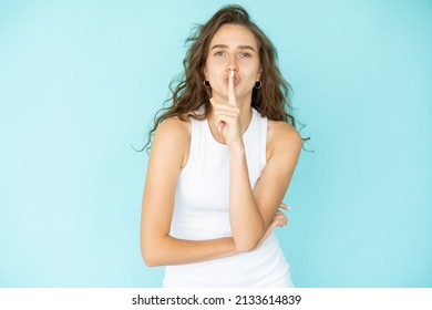 Keep Secret. Silent Woman. Mute Expression. Pretty Beautiful Lady White Dress Holding Shush Finger On Mouth Isolated Blue.