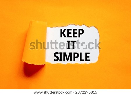 Keep it simple symbol. Concept word Keep it simple on beautiful white paper. Beautiful orange table orange background. Business motivational keep it simple concept. Copy space.