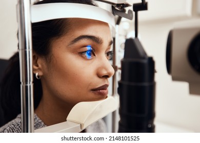 Keep As Still As Possible. Shot Of A Young Woman Getting Her Eyes Examined With A Slit Lamp.