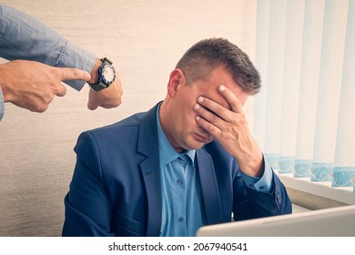 Keep track of time. man point at clock. being late at work. The boss scolds the employee for being late or overdue work. Work time or working hours. Time management. Office life. Time for work - Shutterstock ID 2067940541