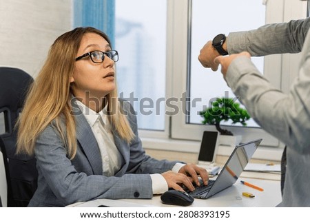 Keep track of time. man point at clock. Work time or working hours. Time management. Office life. Time for work. being late at work. The boss scolds the employee for being late or overdue work.