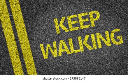 Keep Walking Written On The Road