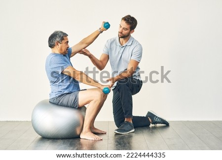 Keep your form. Full length shot of a young male physiotherapist assisting a senior patient in recovery.