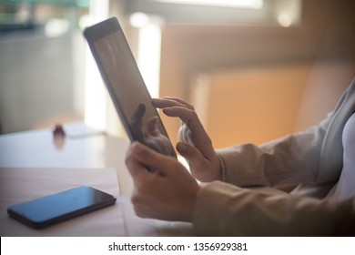 Keep your job in your hands. Business woman working on digital tablet. Close up.
