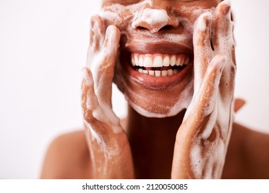 Keeping my skin clean is what keeps it looking good. Studio shot of an unrecognizable woman washing her face against a white background. - Powered by Shutterstock