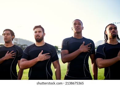 Keeping up with traditions. Cropped shot of a diverse group of sportsmen standing together and singing their national anthem before playing rugby. - Powered by Shutterstock