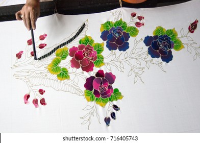 KELANTAN, MALAYSIA - 15 July 2017: Unidentified batik maker use watercolor to color on the fabric to make Batik. Batik-making is part of Malaysian culture and tourist attraction in Kelantan, Malaysia.