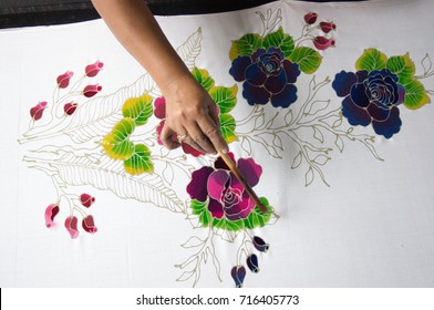 KELANTAN, MALAYSIA - 15 July 2017: Unidentified batik maker use watercolor to color on the fabric to make Batik. Batik-making is part of Malaysian culture and tourist attraction in Kelantan, Malaysia.