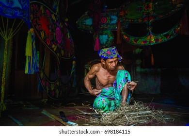 KELANTAN, MALAYSIA - 15TH JULY 2017; Unidentified Man Is Making The Traditional Moon Kite Or Locally Known As 