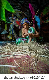 KELANTAN, MALAYSIA - 15TH JULY 2017; Unidentified Man Is Making The Traditional Moon Kite Or Locally Known As 