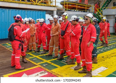 KELANTAN, MALAYSIA - AUG  15TH 2019 : Unidentified offshore workers standing and assemble on main deck barge to check namelist prior to transfer to oil and gas platform.