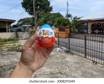 Kelantan, Malaysia - July 15 2021: A Picture Of A Hand Holding A Kinder Joy. 