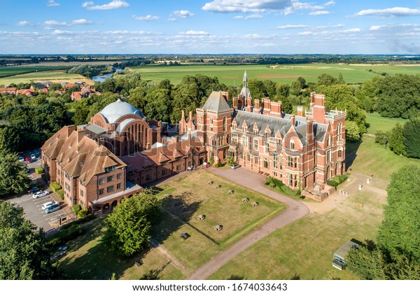Kelham, Nottinghamshire, England, UK - August 2,\
2018: Kelham Hall - the  masterpiece of Victorian Gothic style near\
Newark-on-Trent with a hotel, conference center, spa, park and\
camping. Aerial view