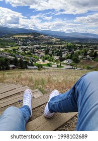 Kelowna, British Columbia, Canada- 20 June, 2021: A Photo Of A Person With Chuck Taylors Sneakers Hiking To Top Of Black Mountain Hill Top Viewpoint In Kelowna, Okanagan Valley Overseeing Lake 