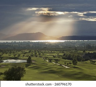 Kelowna And Golf Course By The Lake In Sunset