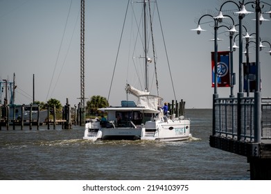 Kemah, TX, US - March 23, 2022: A Catamaran Sailboat Passing By Kemah Boardwalk As It Heads Out To Galveston Bay In Kemah Texas.