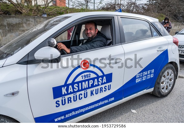 Kemerburgaz,\
Istanbul, Turkey - 03.19.2021: middle aged male instructor of\
driving test car sitting on car seat in Turkey before test day.\
Translation on car: Kasimpasa Driving\
Course