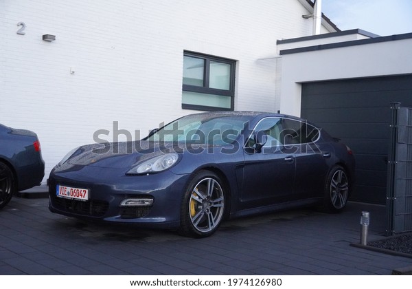 Kempen,Germany-May 15,2021: Blue Porsche\
Panamera parks at home,  is a full-sized luxury vehicle (E-segment\
in Europe) manufactured by the German automobile manufacturer\
Porsche produced\
2009-present.