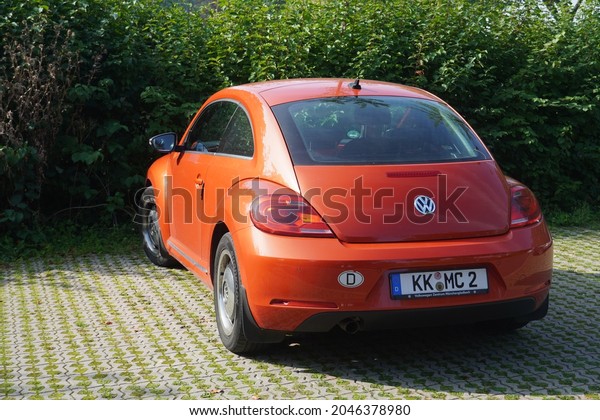 Kempen,Germany-September 18,2021: Orange Volkswagen\
new Beetle coupe in Kempen,is a compact car drawing heavy\
inspiration from the exterior design of the original\
Beetle.Produced from 1997 –\
2011