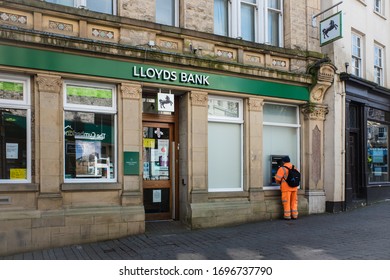 Kendal Cumbria UK April 6th 2020 The Outside Of A Lloyds Bank Man Using Cash Point Kendal