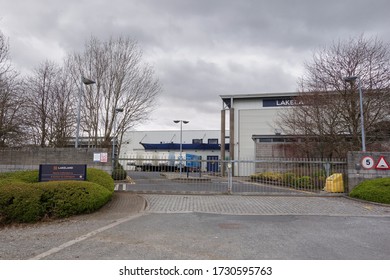 Kendal, Cumbria, UK - March 28 2020: The Closed Gates Of The Distribution Centre Of A Home Shopping Business Due To The Coronavirus, Covid 19 Pandemic                                