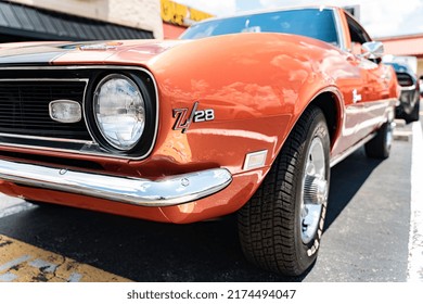 Kennesaw, Georgia  USA - July 3, 2022: Front Fender Of A Classic Car Parked In A Lot In Front Of Some Billboards. 