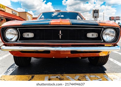 Kennesaw, Georgia  USA - July 3, 2022: Front Grill Of A Classic Car Parked In A Lot In Front Of Some Billboards. 