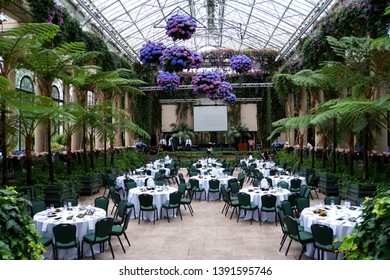 Kenneth Square, Pennsylvania, U.S.A - May 4, 2019 - Beautiful Wedding Reception Area Decorated With Green Tropical Trees And Blue Hydrangea Flowers