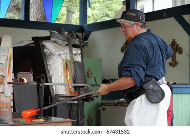 KENOSHA, WI - SEPTEMBER 4: Demonstration of making a cup from a molten glass at the annual Bristol Renaissance Faire on September 4, 2010 in Kenosha, WI