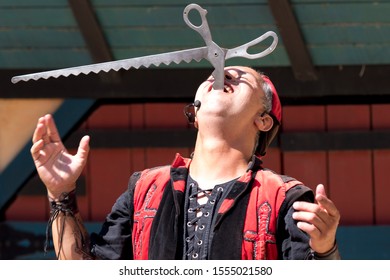 KENOSHA, WISCONSIN - AUGUST 3, 2019: Actor Perform A Sword Swallowing Act At The Annual Bristol Renaissance Faire