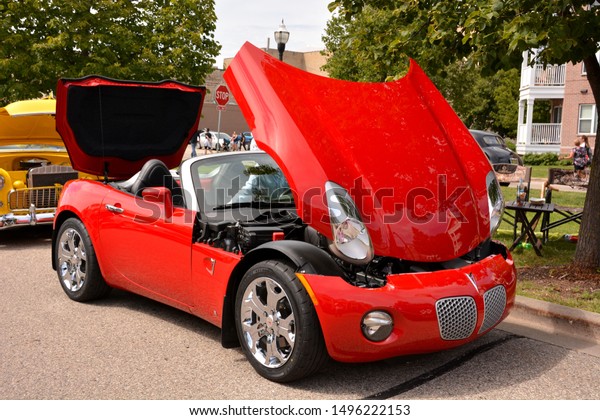 Kenosha, Wisconsin / USA -\
August 31, 2019:  A 2009 Red Pontiac Solstice convertible on\
display at the downtown Kenosha car show with hood bonnet and trunk\
boot open. 