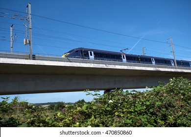 Kent, England, UK. 9th August 2016: The Javelin High Speed Train Crosses The River Medway Travelling Towards The Coast At High Speed.