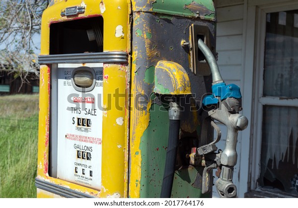 Kent, Oregon, USA - May 16, 2015: An antique yellow\
and green gas pump