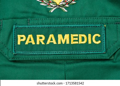 Kent, UK. 11th April 2020.  Close Up View Of A British PARAMEDIC Badge Sewn Onto Green Paramedic Shirt.