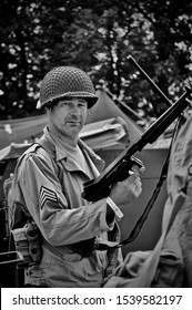 KENT WAR AND PEACE SHOW,ENGLAND-22JULY 2010.US Army sergeant  poses with his Tommy gun.