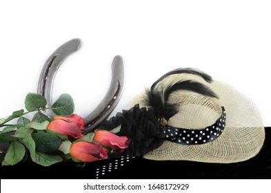 Kentucky Derby Photo Of A Fascinator Hot With Red Roses And A Horseshoe. On A Black Table With White Background