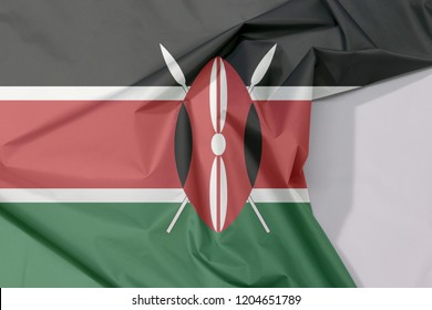 Kenya Fabric Flag Crepe And Crease With White Space, Black White Red And Green With Two Crossed White Spears Behind A Red, And Black Maasai Shield.