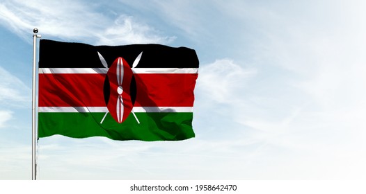 Kenya flag in the blue sky. Horizontal panoramic banner.