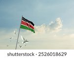 Kenya flag waving with flying doves in beautiful sky. Kenya flag for Republic Day and Independence Day.