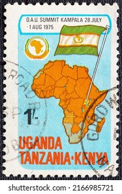 KENYA UGANDA TANZANIA - CIRCA 1975: A Stamp Printed In Kenya Uganda Tanzania Shows OAU Emblem And: Map Showing OAU Members, Ugandan Flag, Circa 1975.