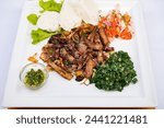 Kenyan cuisine includes ugali, chapati, githeri, goat, Nyama Choma, stews, samosas and sukuma wiki. Ugali is a maize meal, similar to American grits, which is simply cooked in boiling water until it h