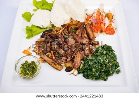 Kenyan cuisine includes ugali, chapati, githeri, goat, Nyama Choma, stews, samosas and sukuma wiki. Ugali is a maize meal, similar to American grits, which is simply cooked in boiling water until it h